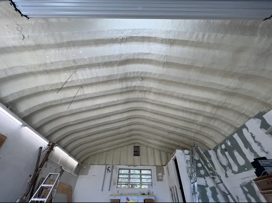 Spray polyurethane foam applied to the underside of a metal roof deck in North Tustin